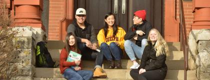 English Language Programs students sitting on steps on campus.
